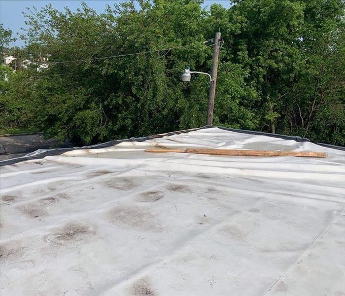 Recently storm damaged roof covered with 